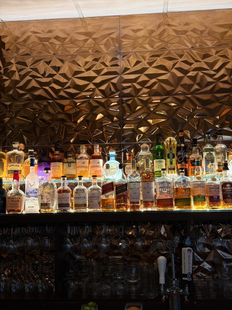 Warmly lit dining room at Treasury Indian Kitchen, an upscale Indian restaurant in Burlington, Massachusetts